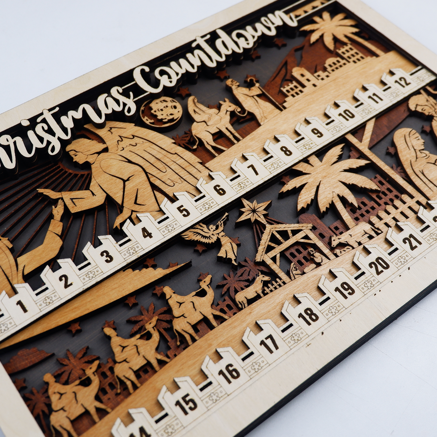Close-up of engraved nativity scene detail on Christmas countdown wood sign