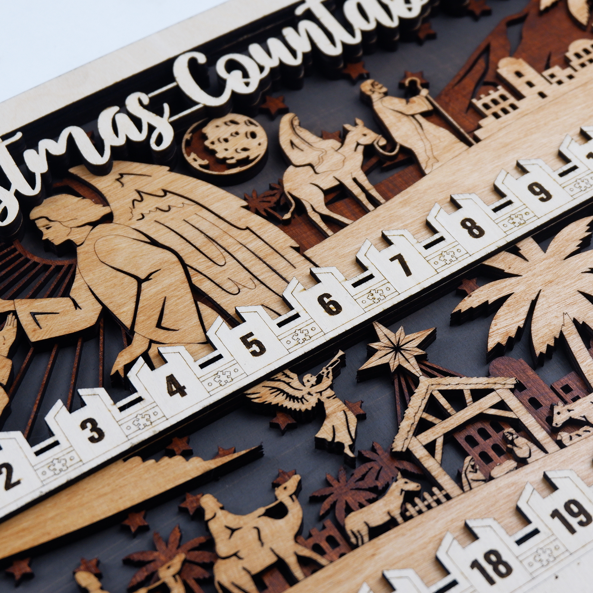 Side view showing depth and hand-stained wood grain of nativity countdown decor