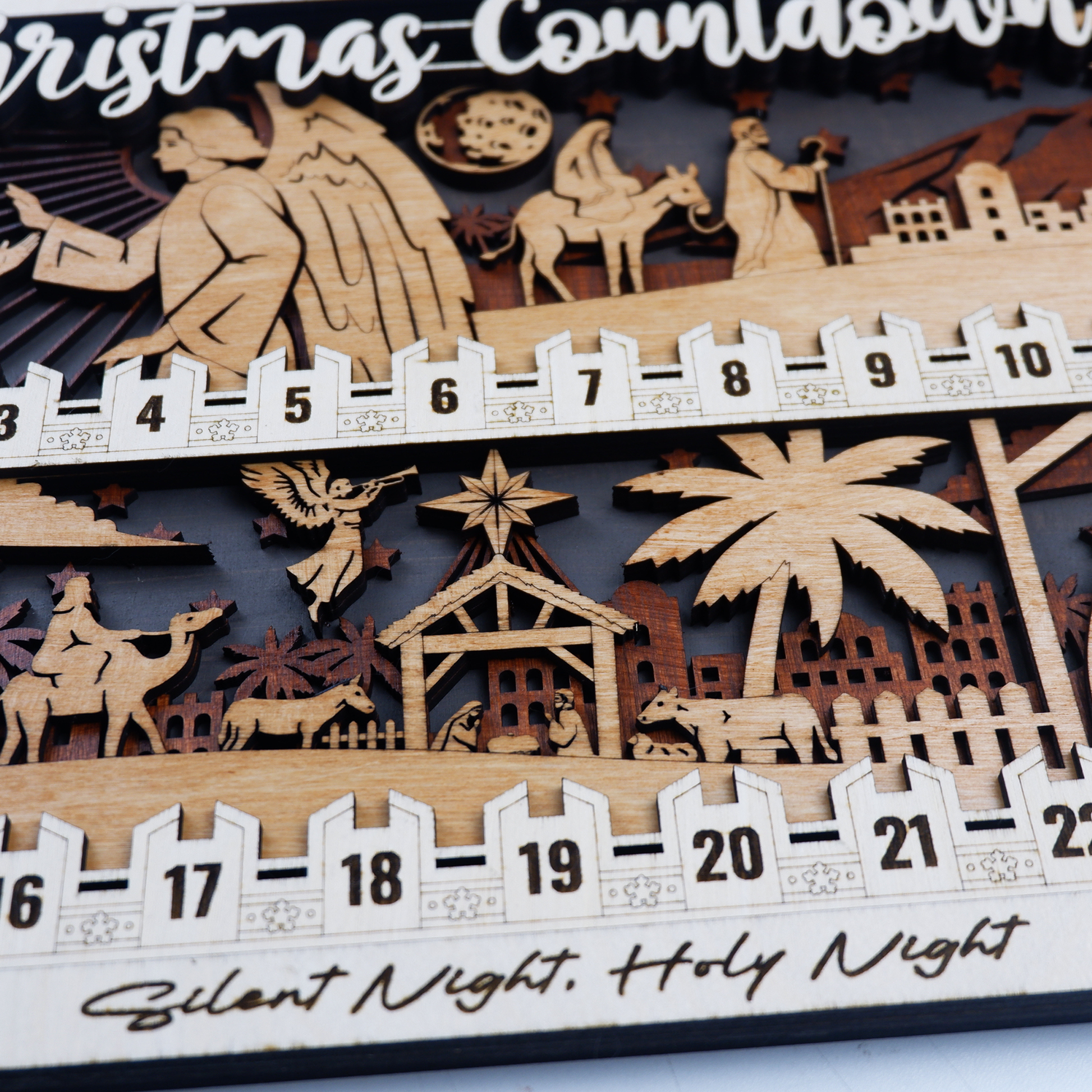 Nativity Christmas countdown displayed on mantel with candles and holiday greenery