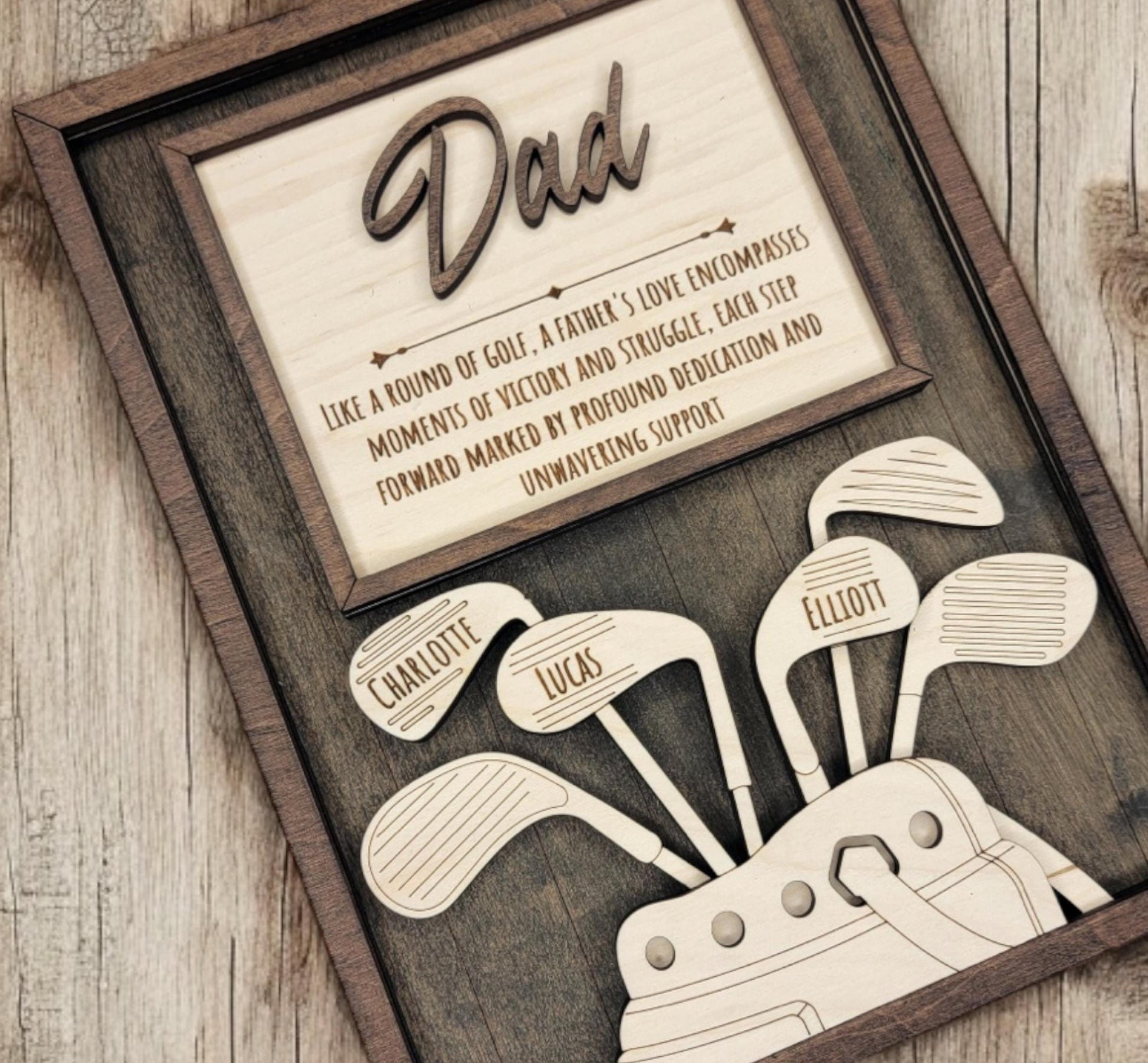 Close-up of engraved golf clubs and kids’ names on personalized wooden golf sign – laser cut detail on hand-stained wood