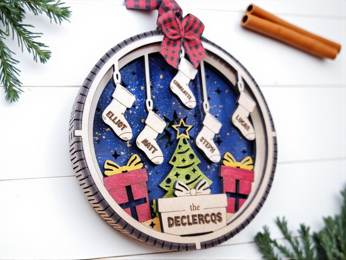 Engraved family with pets ornament displayed on holiday greenery