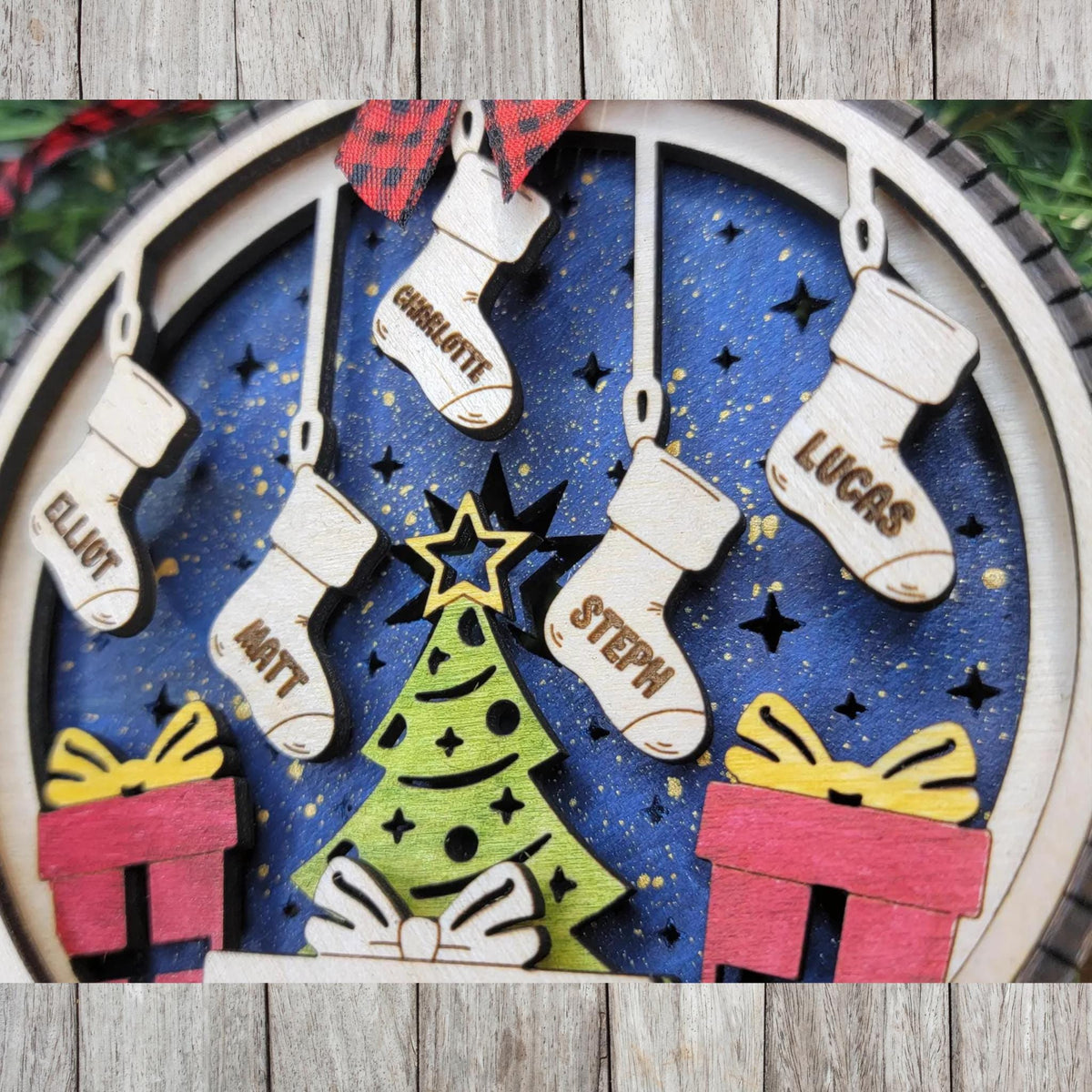Custom wood ornament showing engraved names for family and pets